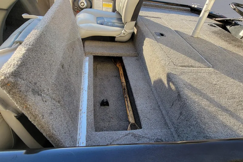 Slide: The Image of 2018 Bass Tracker Pro 16 boat interior with open storage compartment. - 13