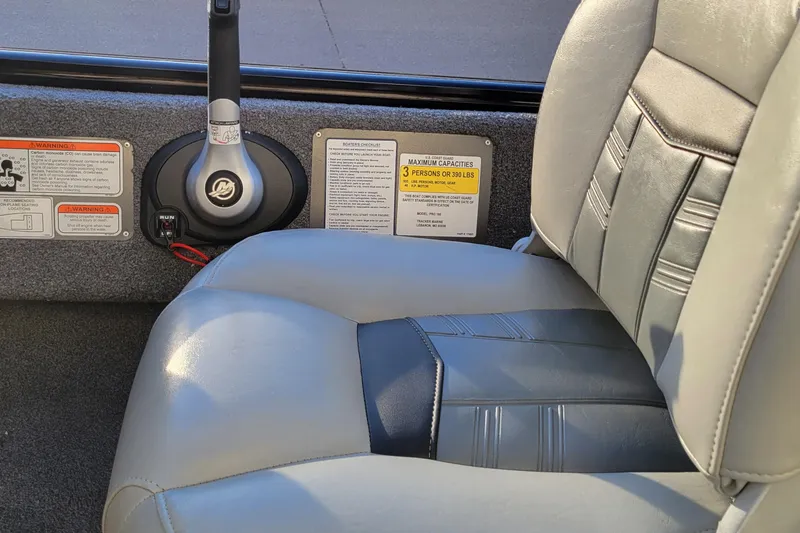 Slide: The Image of 2018 Bass Tracker Pro 16 boat interior with steering controls and seating. - 14