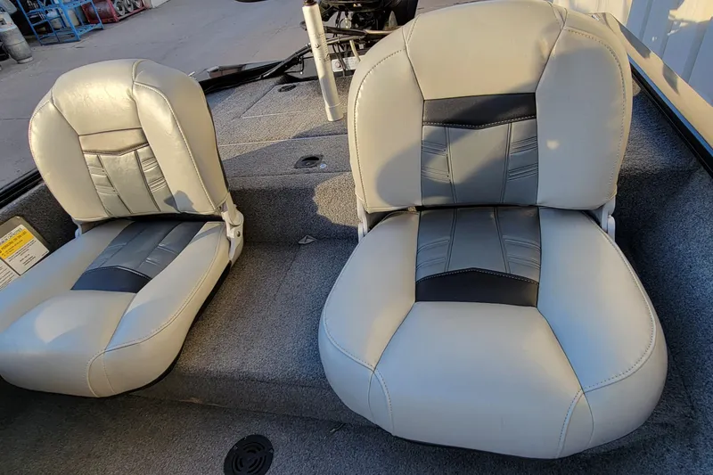 Slide: The Image of 2018 Bass Tracker Pro 16 boat seats, gray and black upholstery, outdoor setting. - 16