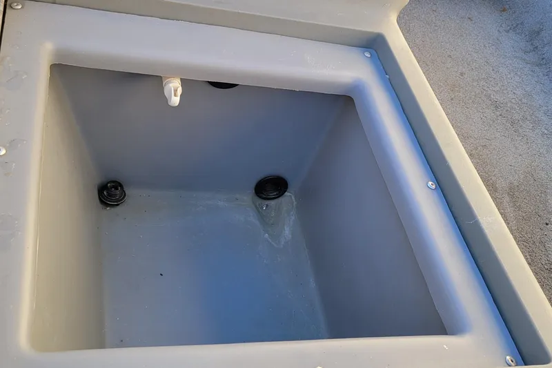 Slide: The Image of Empty livewell compartment in a 2018 Bass Tracker Pro 16 boat. - 23
