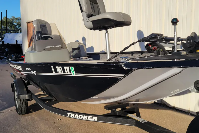 Slide: The Image of 2018 Bass Tracker Pro 16 fishing boat on trailer, parked outdoors. - 28