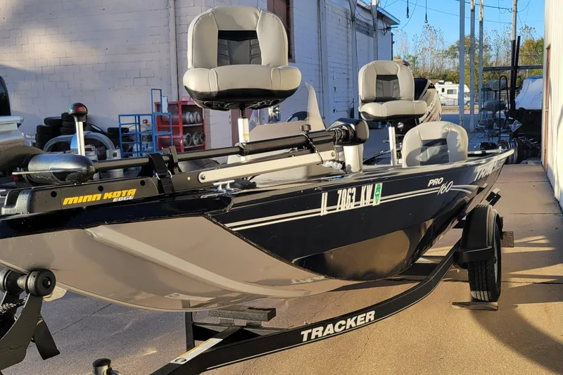 Slide: The Image of 2018 Bass Tracker Pro 16 fishing boat on trailer, equipped with Minn Kota motor. - 29