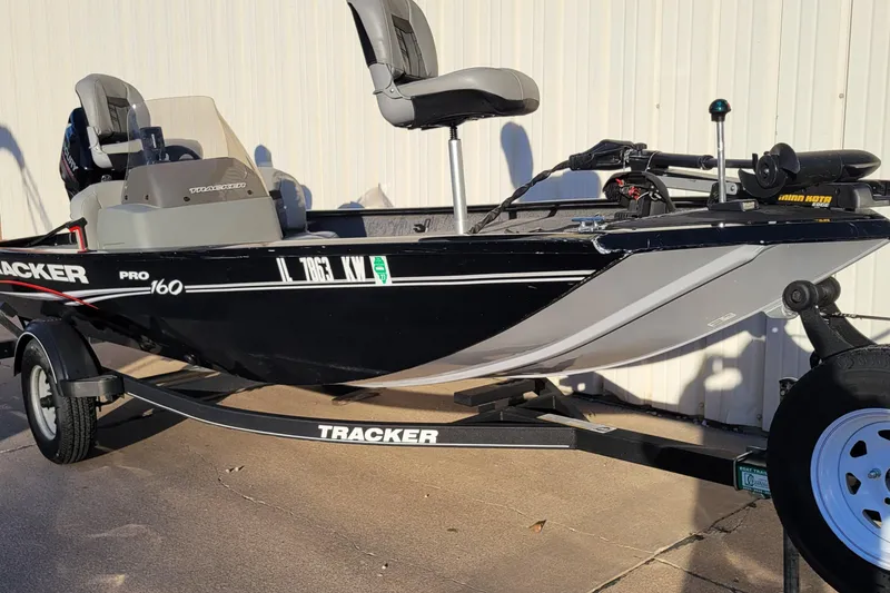 Slide: The Image of 2018 Bass Tracker Pro 16 fishing boat on trailer, parked outdoors. - 30