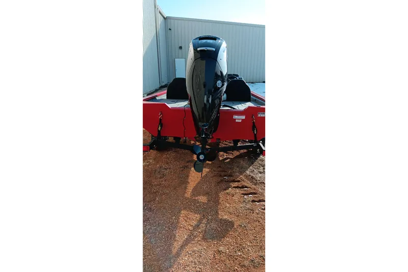 Slide: The Image of 2026 Tracker Pro Team 175 boat with outboard motor, parked outdoors. - 11