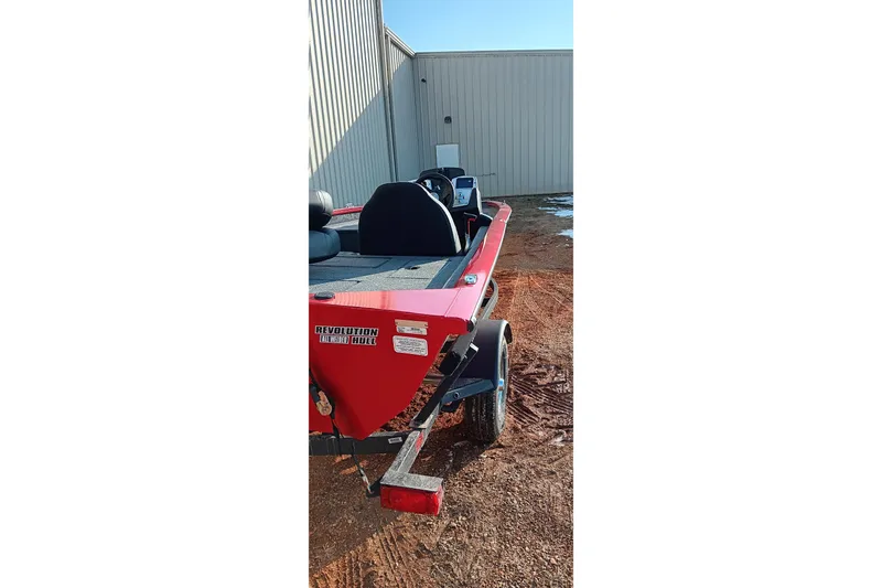 Slide: The Image of 2026 Tracker Pro Team 175 boat with red hull parked outdoors. - 13