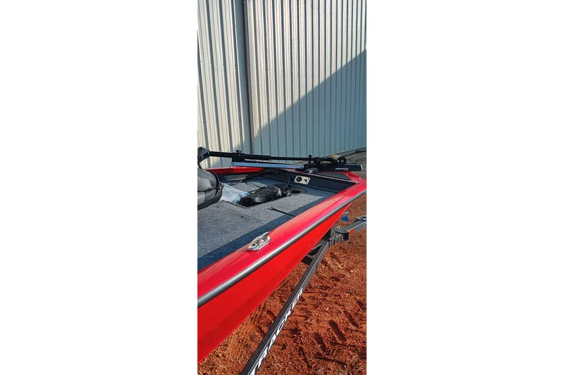 Slide: The Image of 2026 Tracker Pro Team 175 boat, red exterior, parked on trailer near metal building. - 15