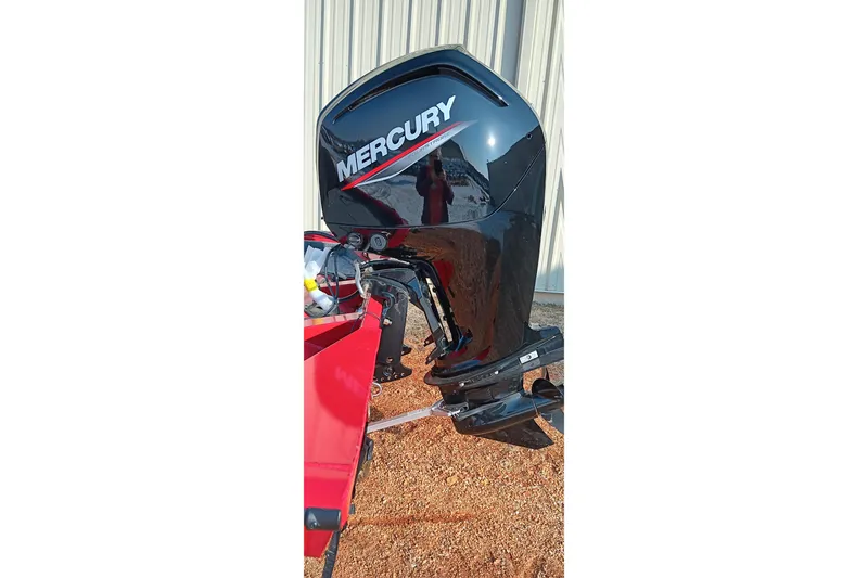 Slide: The Image of 2026 Tracker Pro Team 175 with Mercury outboard motor, parked on gravel. - 6