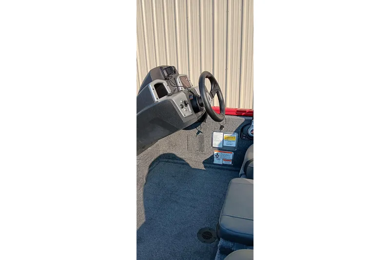 Slide: The Image of 2026 Tracker Pro Team 175 boat interior with steering wheel and control panel. - 7