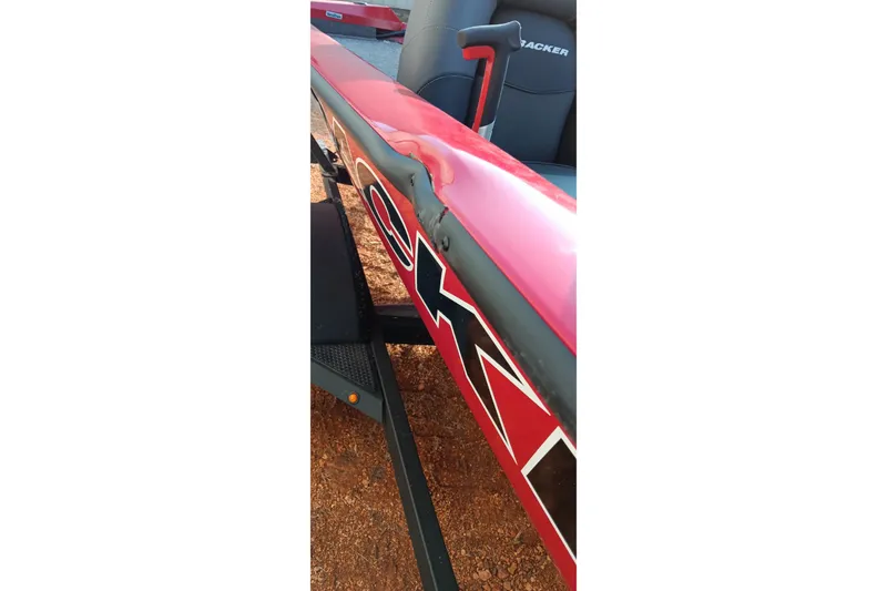 Slide: The Image of 2026 Tracker Pro Team 175 boat with visible damage on the red side panel. - 9