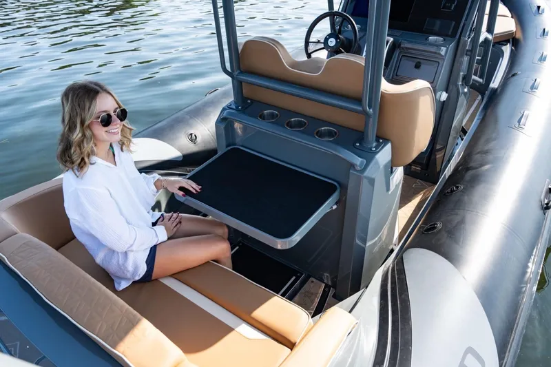 Slide: The Image of Woman relaxing on a 2026 Highfield Escape 650 boat, enjoying the water. - 10