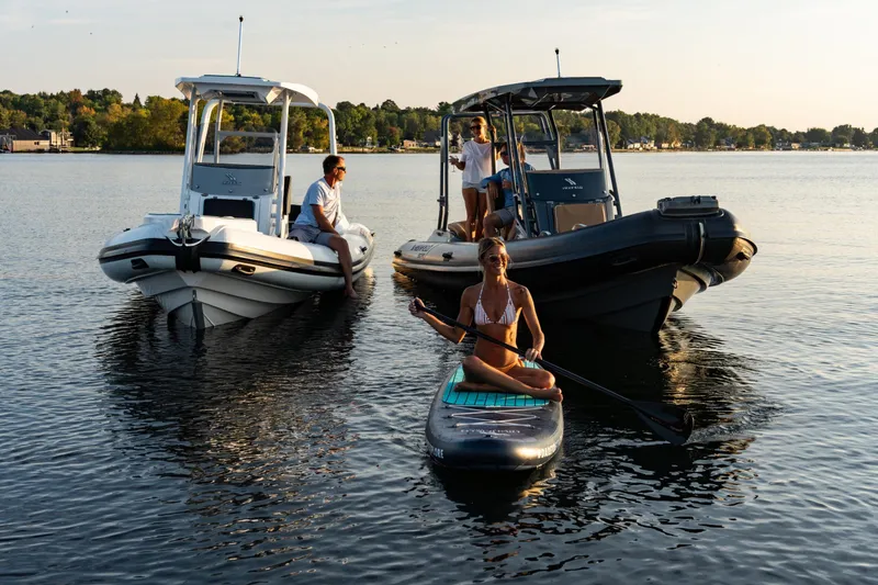 Slide: The Image of People enjoying water activities with Highfield Escape 650 boats, 2026 model, on a sunny day. - 14