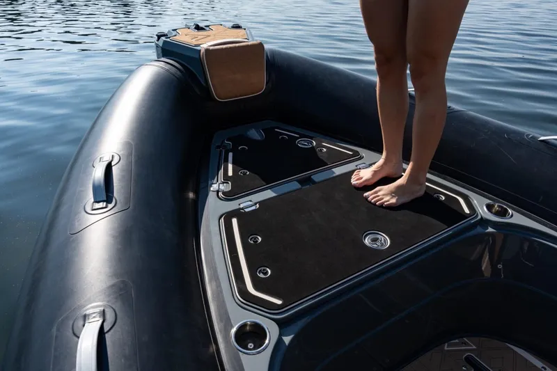 Slide: The Image of Person standing on a 2026 Highfield Escape 650 boat deck by the water. - 4