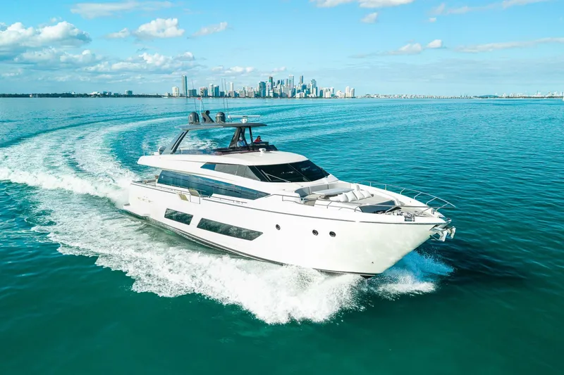 Slide: The Image of Luxurious 2018 Ferretti Yachts 850 cruising near a city skyline on a sunny day. - 10