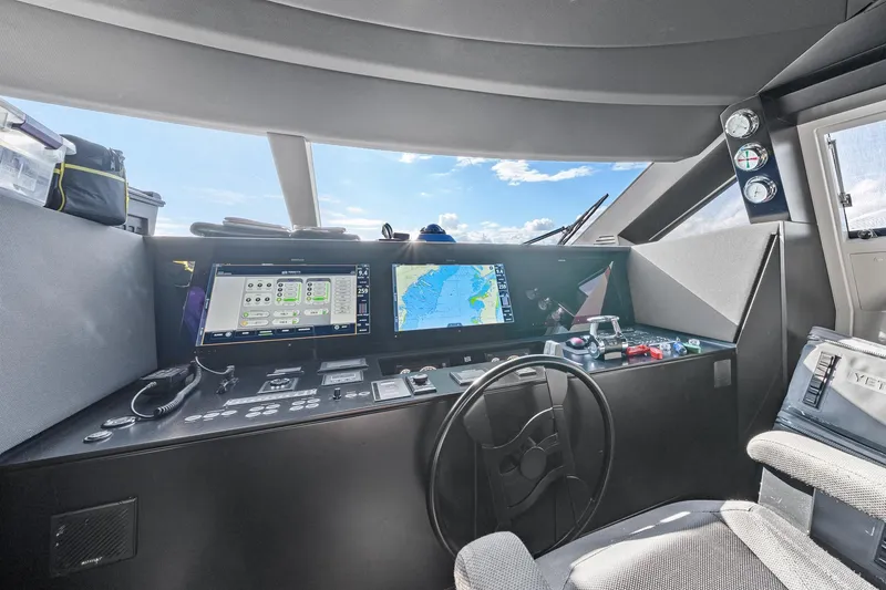Slide: The Image of Cockpit of 2018 Ferretti Yachts 850 with navigation screens and steering wheel. - 37