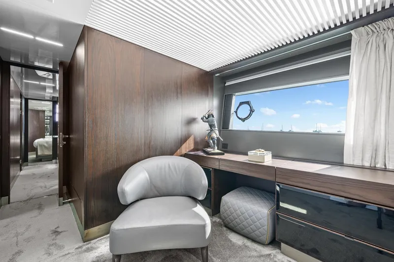 Slide: The Image of Luxurious interior of 2018 Ferretti Yachts 850 with elegant seating and desk, featuring a scenic window view. - 61