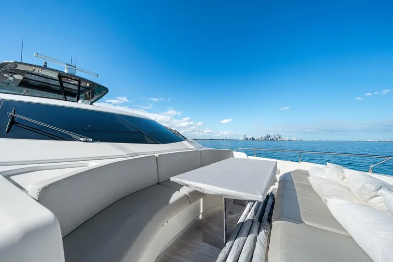 Slide: The Image of Luxurious 2018 Ferretti Yachts 850 with elegant seating, ocean view, and city skyline backdrop. - 73