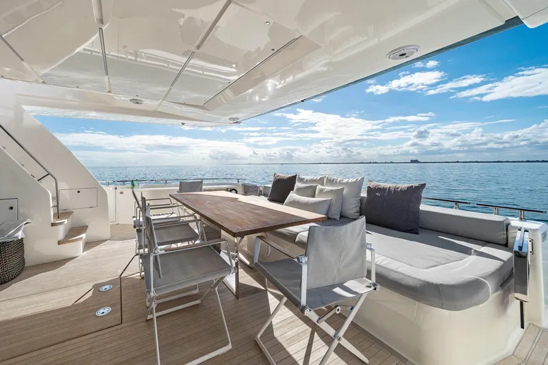 Slide: The Image of Luxurious 2018 Ferretti Yachts 850 deck with seating, table, and ocean view. - 79