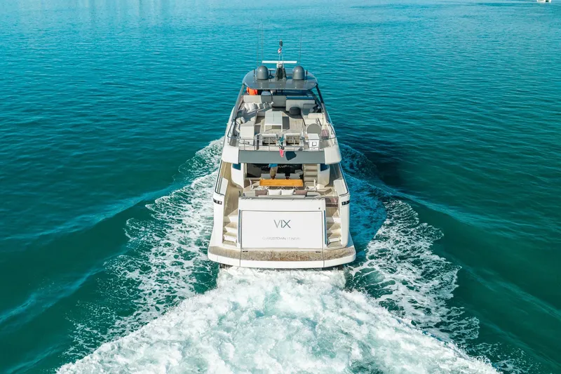 Slide: The Image of 2018 Ferretti Yachts 850 cruising on clear blue water, rear view. - 9
