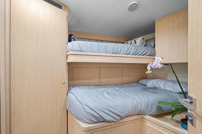 Slide: The Image of Bunk beds in 2018 Ferretti Yachts 850 cabin with light wood finish and orchid decoration. - 90