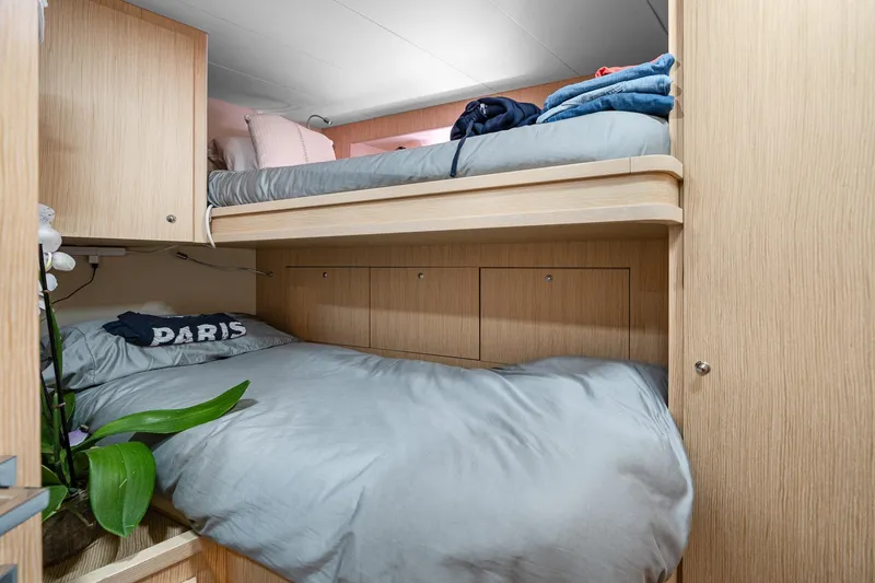 Slide: The Image of Bunk beds in 2018 Ferretti Yachts 850 cabin with light wood finish and cozy bedding. - 92