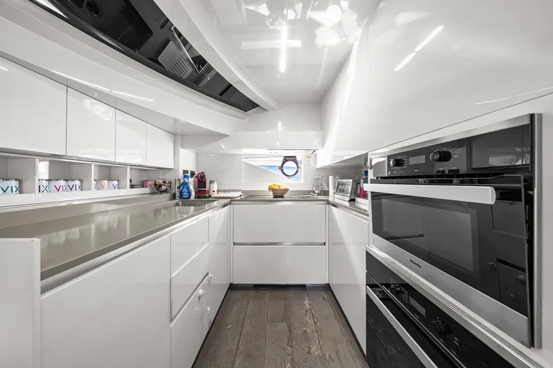Slide: The Image of Modern kitchen interior in 2018 Ferretti Yachts 850, featuring sleek white cabinetry and appliances. - 35