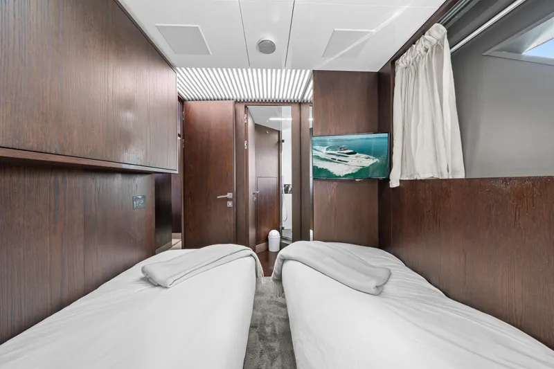 Slide: The Image of Luxurious 2018 Ferretti Yachts 850 cabin with twin beds and modern wood paneling. - 58
