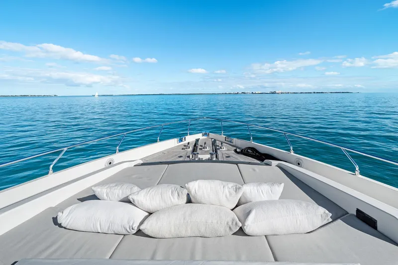 Slide: The Image of Luxurious 2018 Ferretti Yachts 850 deck with cushions, overlooking serene ocean view. - 74