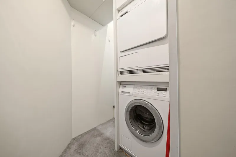 Slide: The Image of Laundry area with stacked washer and dryer on 2018 Ferretti Yachts 850. - 94