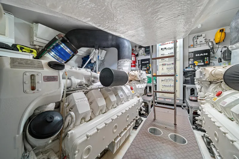 Slide: The Image of Engine room of 2018 Ferretti Yachts 850, featuring dual MAN engines and control panels. - 96