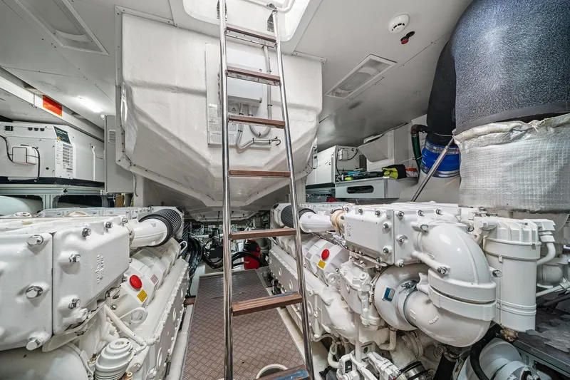 Slide: The Image of Engine room of 2018 Ferretti Yachts 850, featuring dual engines and ladder access. - 99