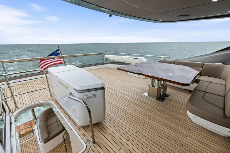 Slide: The Image of Luxurious 2024 Princess X80 yacht deck with seating, table, and ocean view. - 104