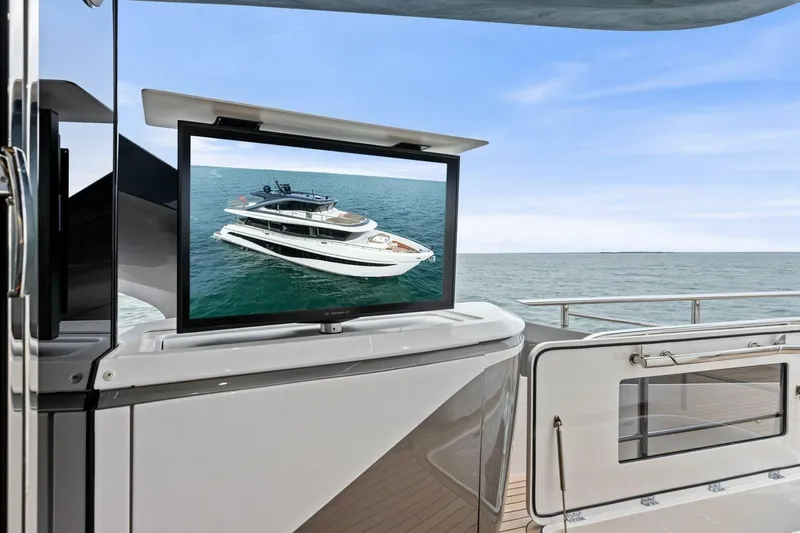 Slide: The Image of 2024 Princess X80 yacht with outdoor TV displaying yacht image, ocean view. - 109