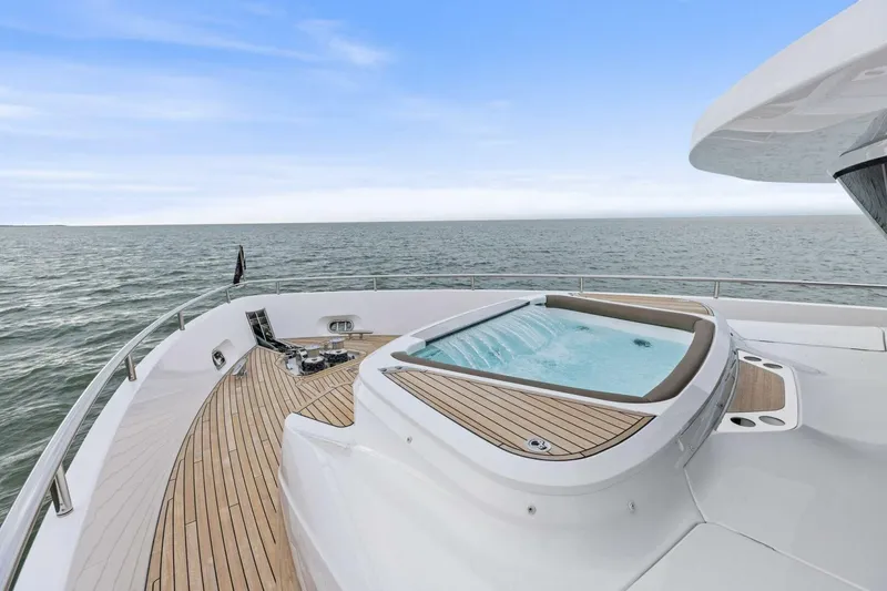 Slide: The Image of Luxurious 2024 Princess X80 yacht deck with jacuzzi, overlooking serene ocean view. - 115