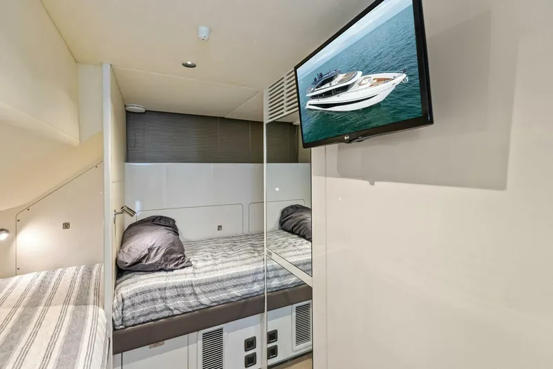 Slide: The Image of Luxurious 2024 Princess X80 yacht cabin with modern bedding and wall-mounted TV. - 122