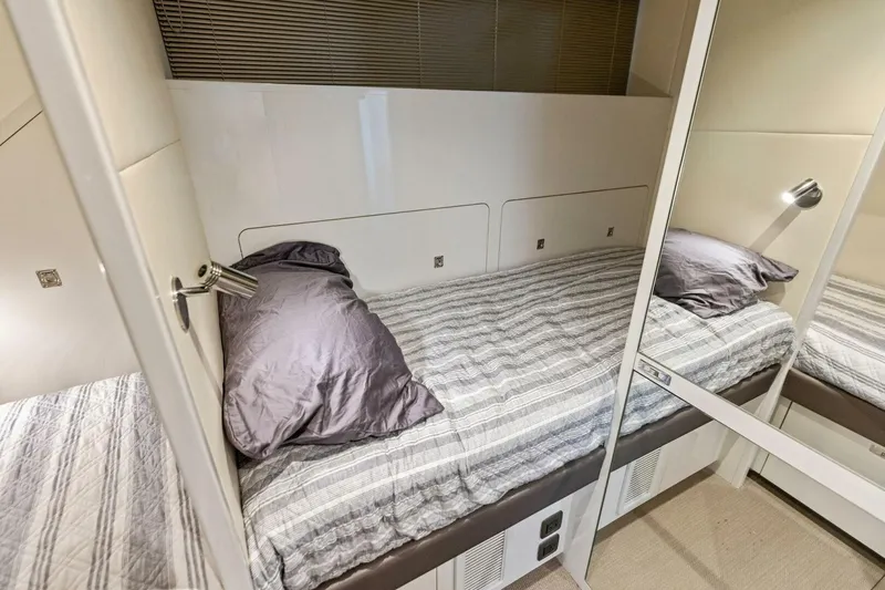 Slide: The Image of 2024 Princess X80 yacht cabin with a cozy single bed and modern decor. - 123