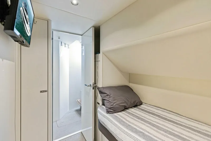 Slide: The Image of 2024 Princess X80 yacht interior with cozy bunk bed and ensuite bathroom. - 124