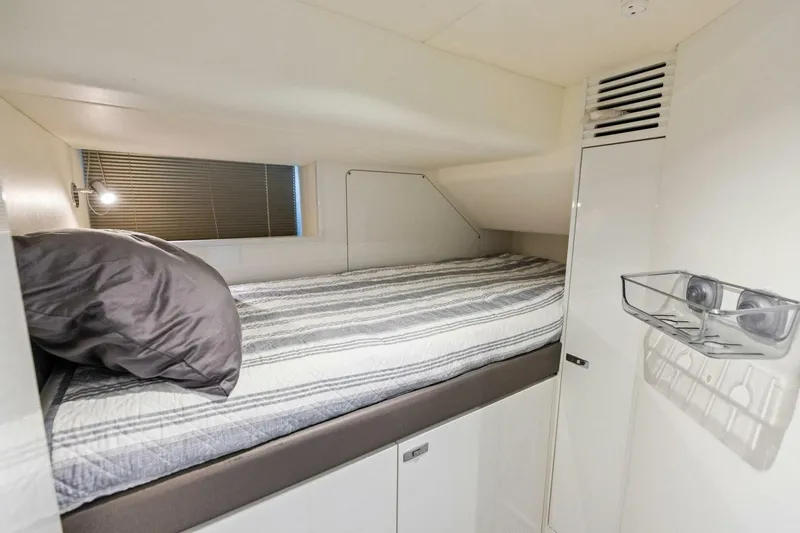 Slide: The Image of Cozy cabin bed in 2024 Princess X80 yacht, featuring modern design and striped bedding. - 125