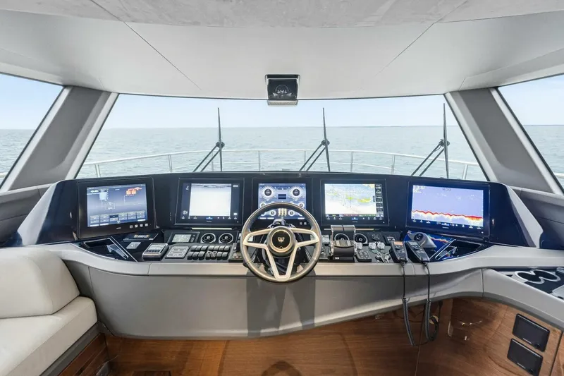 Slide: The Image of 2024 Princess X80 yacht helm with advanced navigation displays and steering wheel. - 16