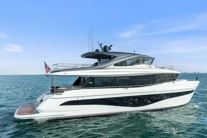 Slide: The Image of 2024 Princess X80 yacht cruising on open water under clear blue sky. - 160