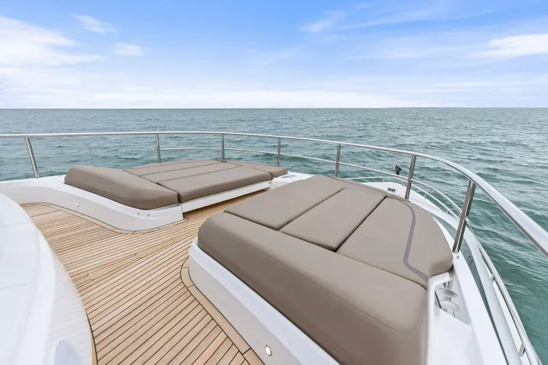 Slide: The Image of Luxurious 2024 Princess X80 yacht deck with sun loungers overlooking the ocean. - 19