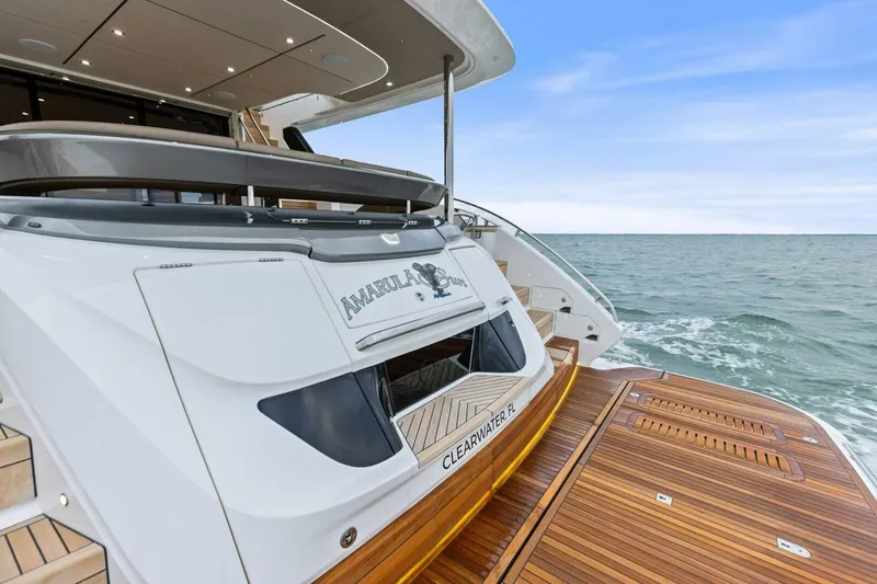 Slide: The Image of 2024 Princess X80 yacht with teak deck, cruising on open sea. - 23