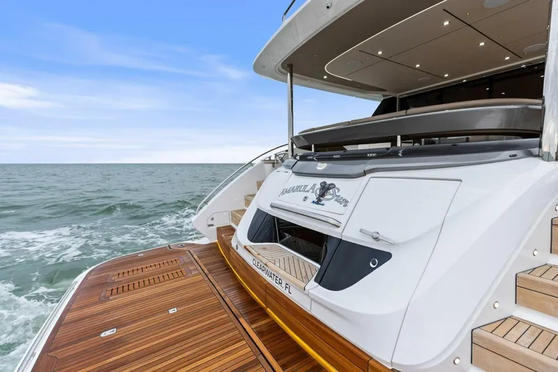Slide: The Image of 2024 Princess X80 yacht on ocean, featuring elegant wooden deck and modern design. - 25