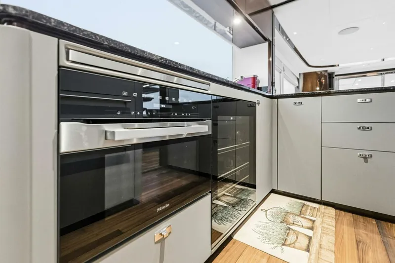 Slide: The Image of Modern kitchen interior in 2024 Princess X80 yacht, featuring sleek appliances and elegant cabinetry. - 35