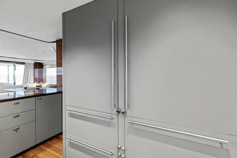 Slide: The Image of Modern kitchen interior on 2024 Princess X80 yacht, featuring sleek cabinetry and wood flooring. - 37