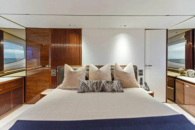 Slide: The Image of Luxurious bedroom interior of 2024 Princess X80 yacht with elegant wood paneling and plush bedding. - 44
