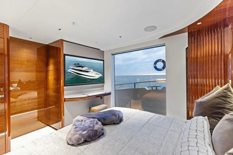 Slide: The Image of Luxurious 2024 Princess X80 yacht bedroom with ocean view and elegant wood finishes. - 60