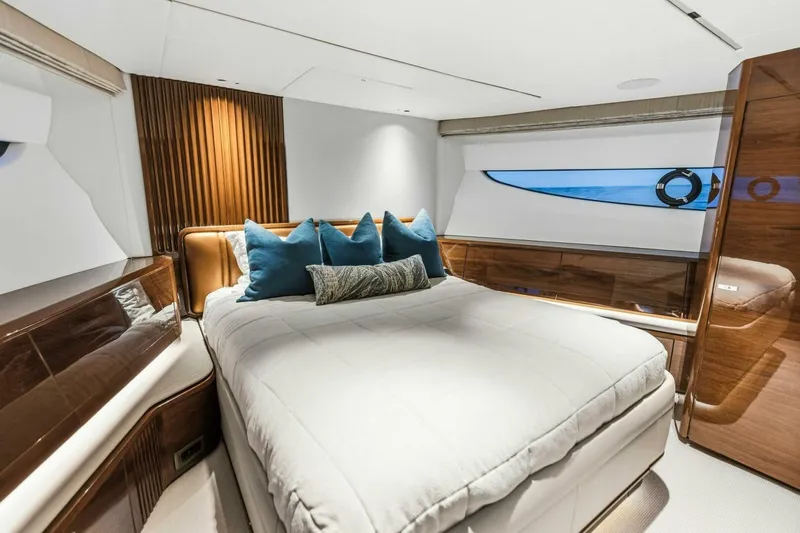 Slide: The Image of Luxurious 2024 Princess X80 yacht bedroom with elegant wood finishes and plush bedding. - 76
