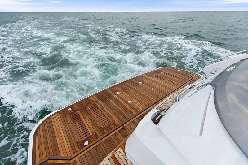 Slide: The Image of Luxury yacht Princess X80 cruising on open sea, showcasing elegant wooden deck, 2024 model. - 87