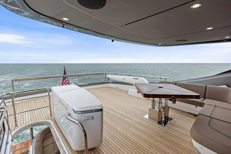 Slide: The Image of Luxurious 2024 Princess X80 yacht deck with ocean view, featuring elegant seating and table. - 97