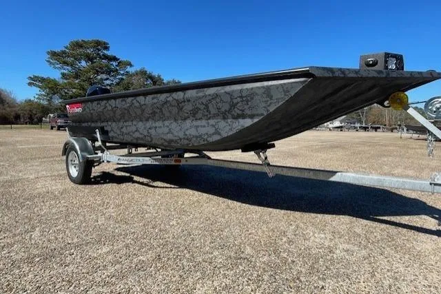 Slide: The Image of 2026 Reaper Boats 553-1689 model on trailer, parked outdoors under clear blue sky. - 2